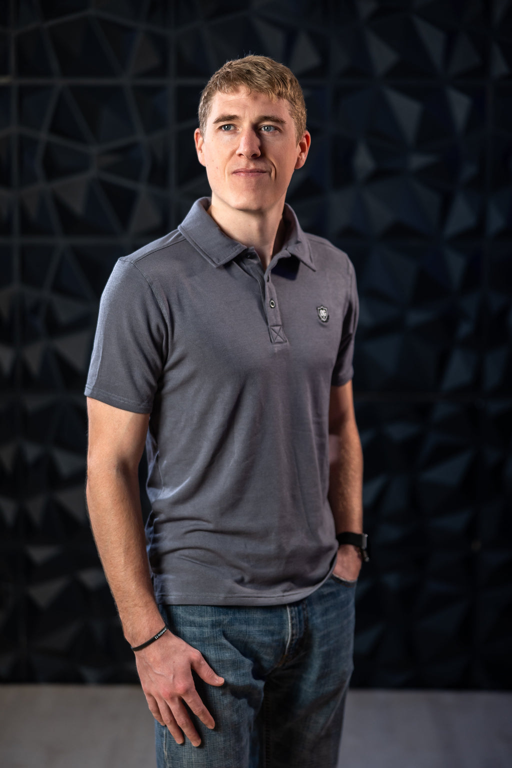 Man wearing grey EMF blocking polo shirt