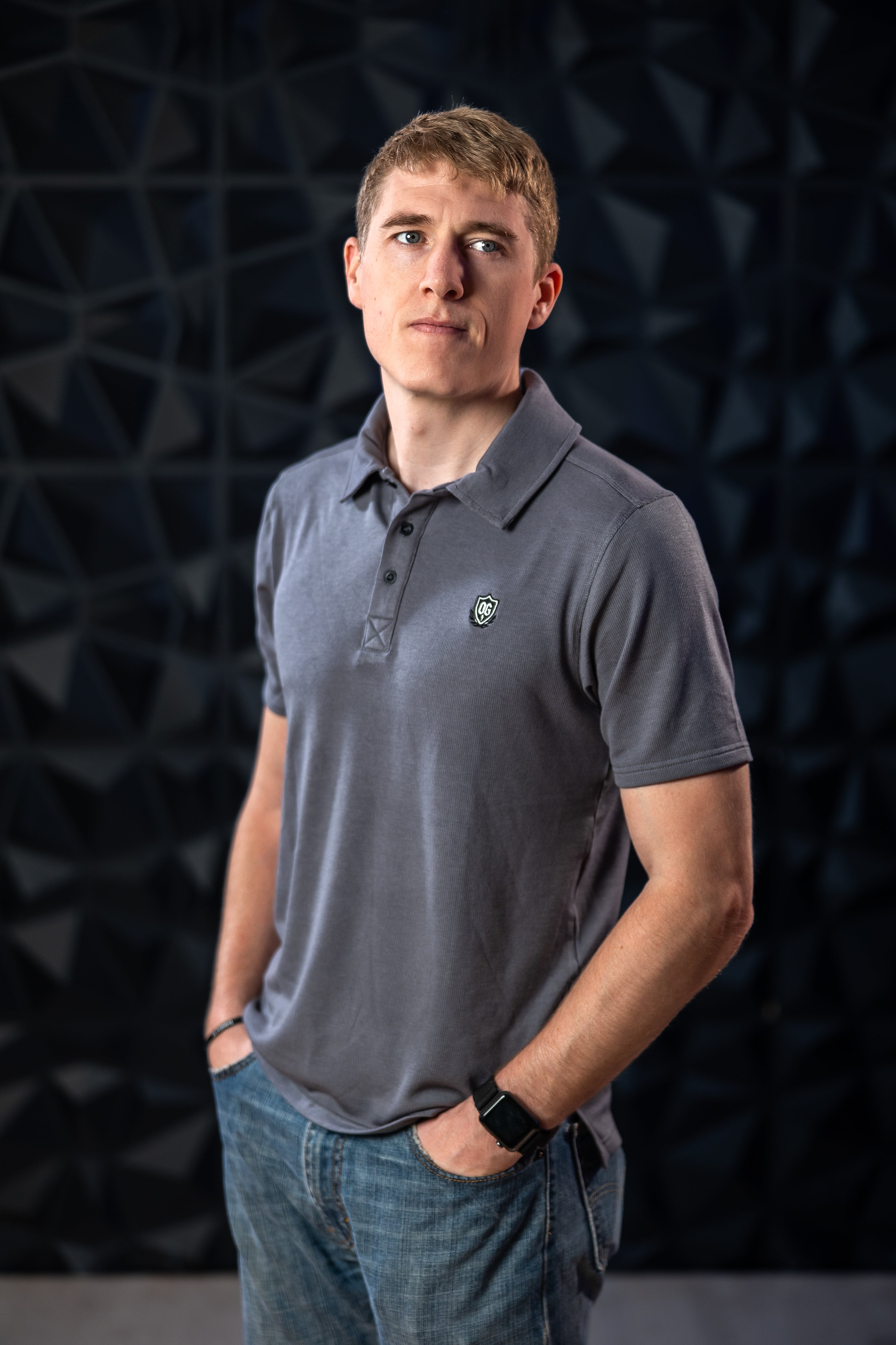 Man wearing grey EMF blocking polo shirt