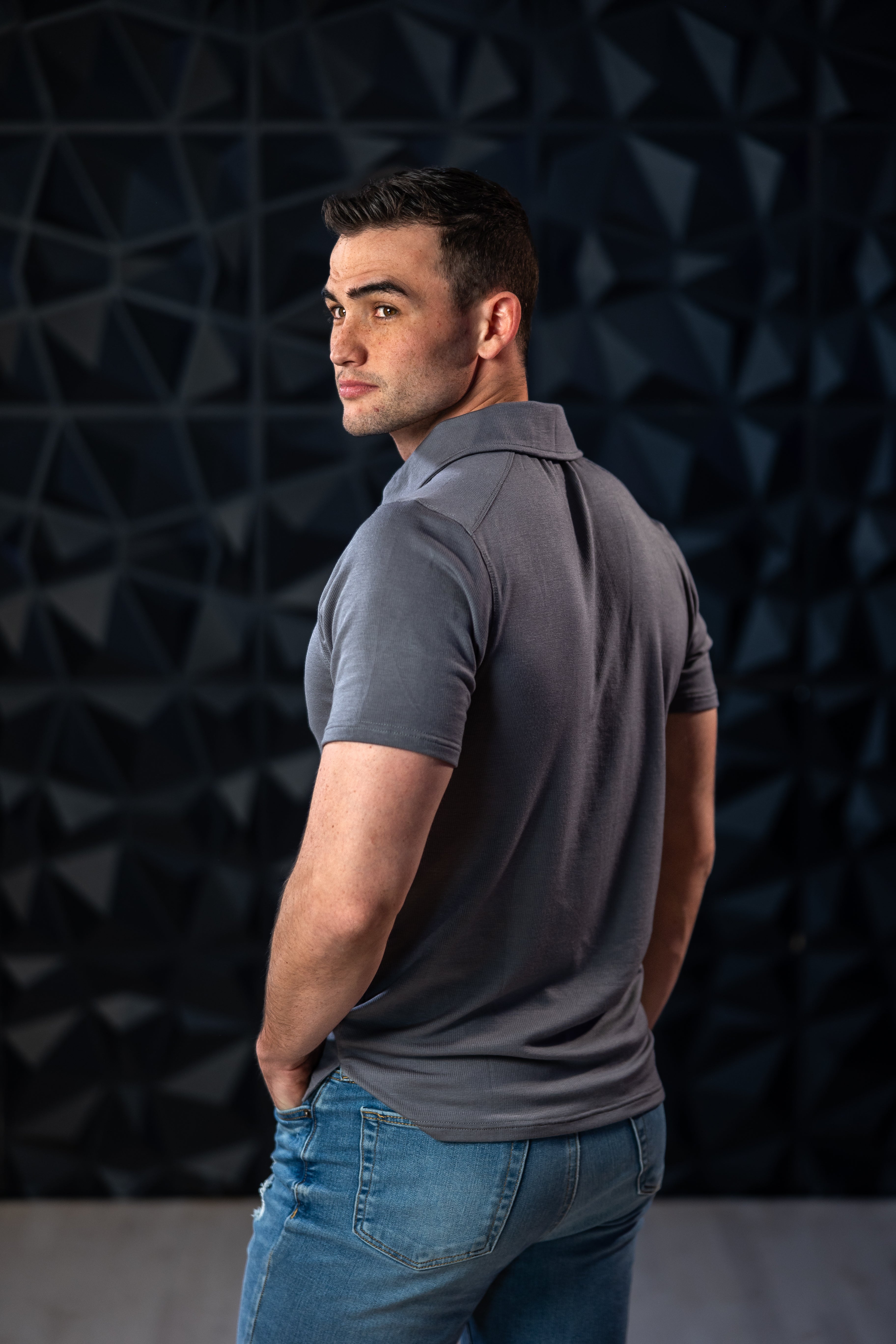 Man wearing grey EMF blocking polo shirt