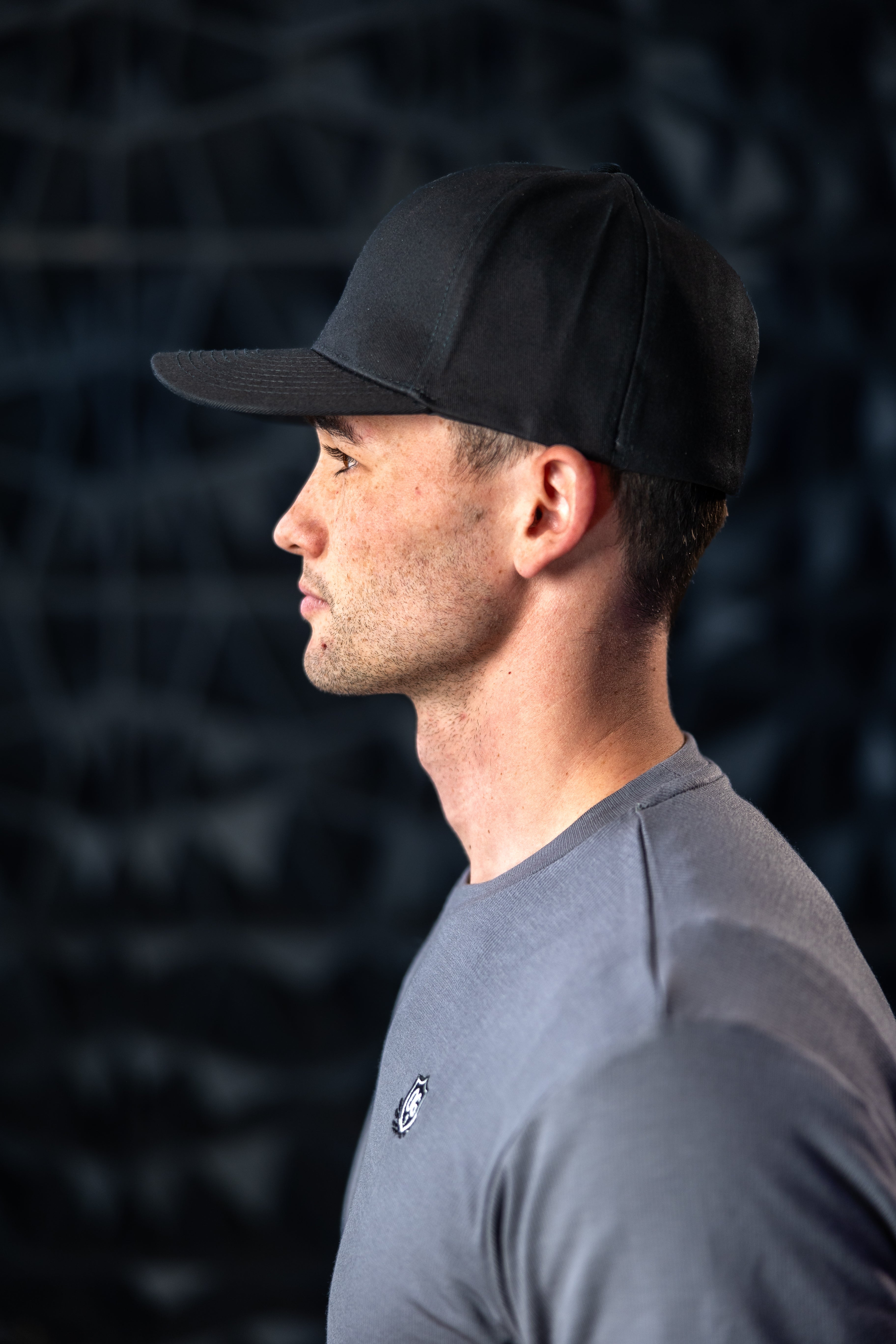 Man with black ball cap on head