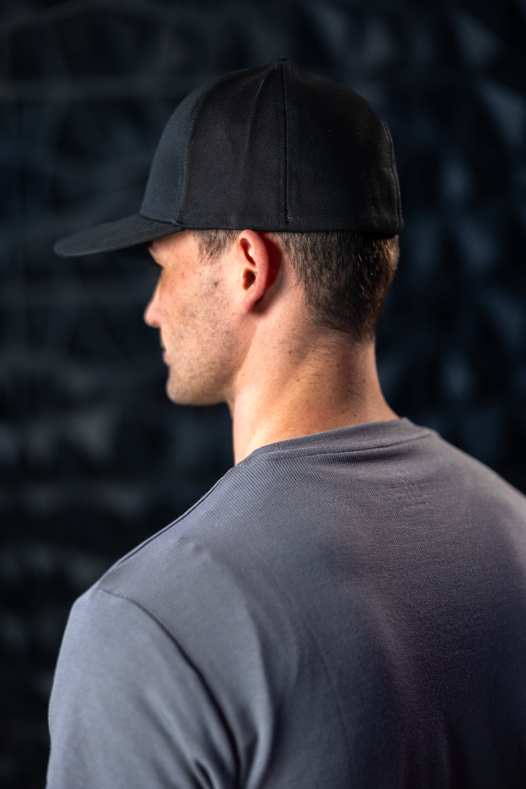 Man with black ball cap on head