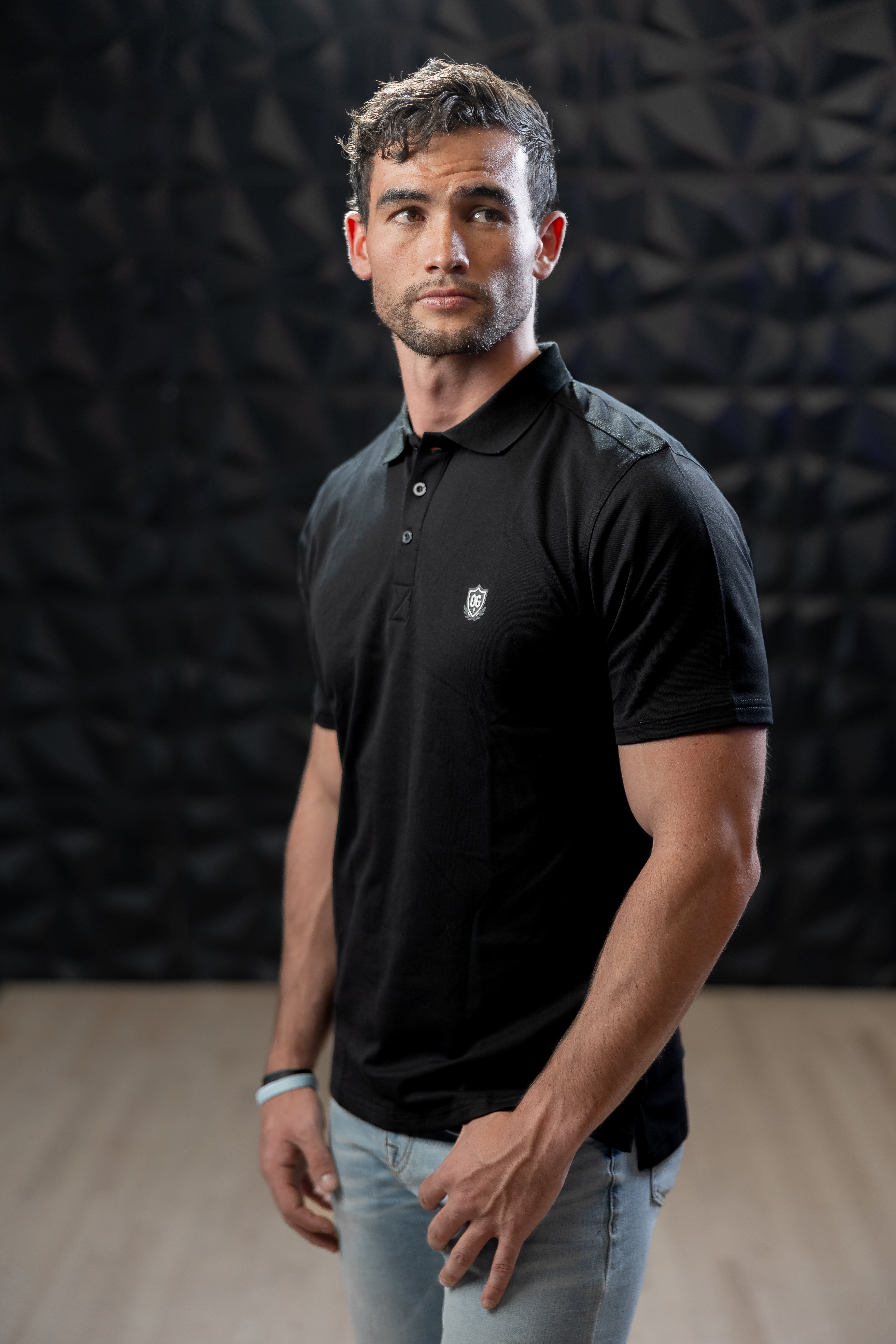 Man wearing black EMF blocking polo shirt