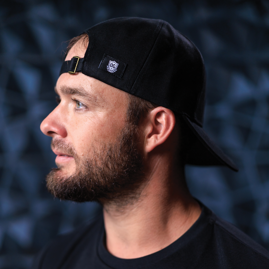 Man with black ball cap on head